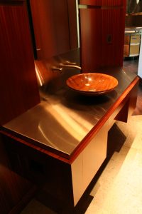 Stainless Steel Counter and Brass Inlays In Wall